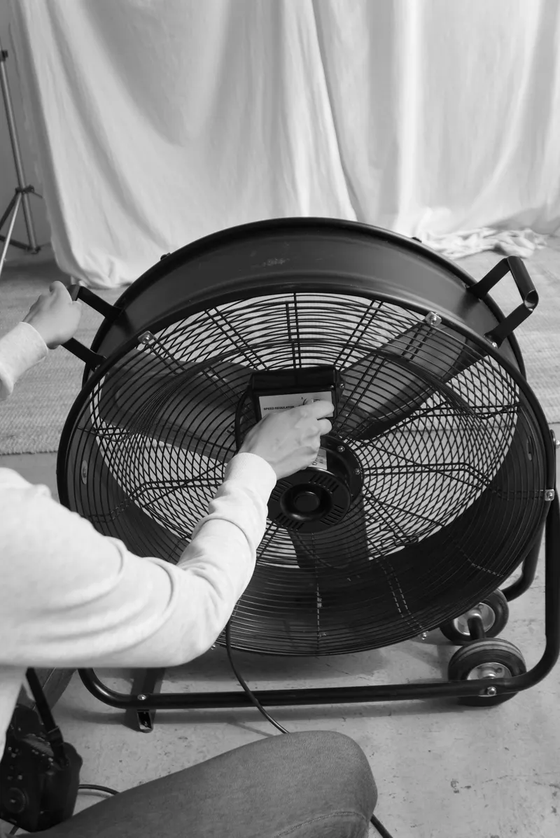 Technician adjusting an industrial air mover