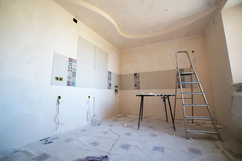 Empty room under renovation with a ladder and stripped walls